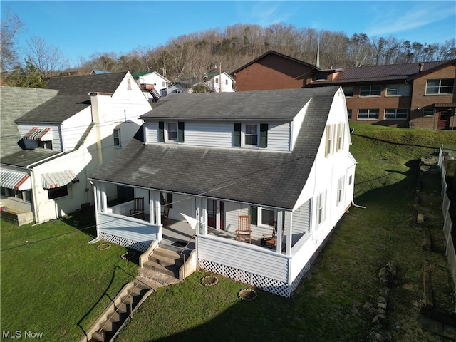 view of front facade featuring a front yard and a deck