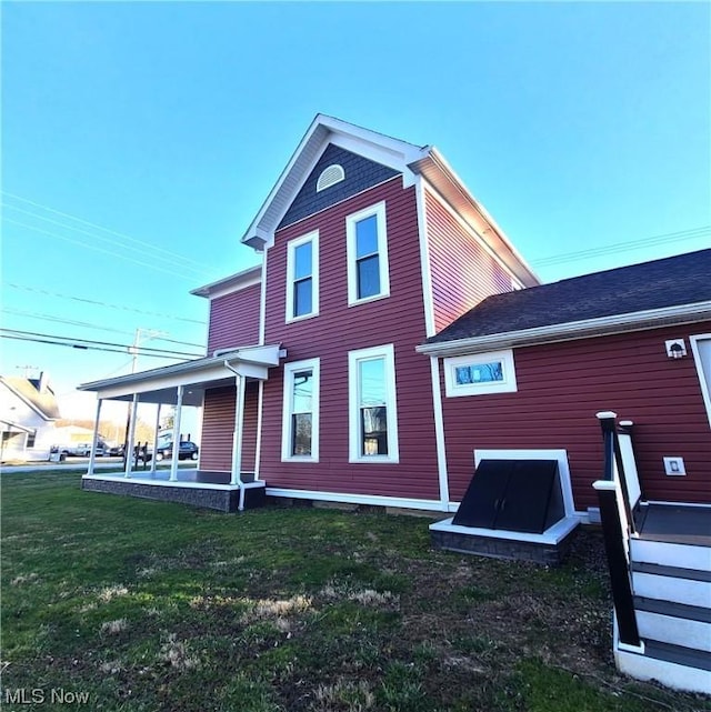 rear view of property with a patio area and a lawn