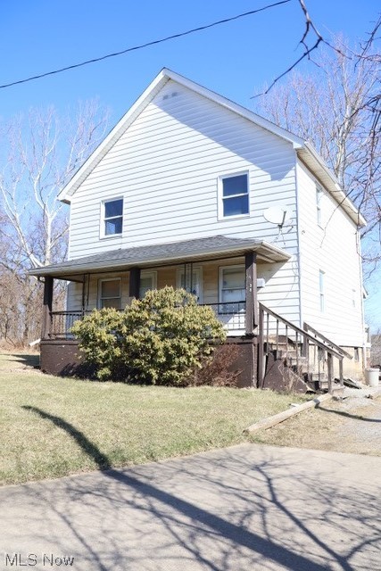 view of front of home with a front yard and a porch