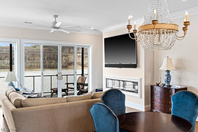 living room with crown molding, ceiling fan with notable chandelier, and hardwood / wood-style flooring