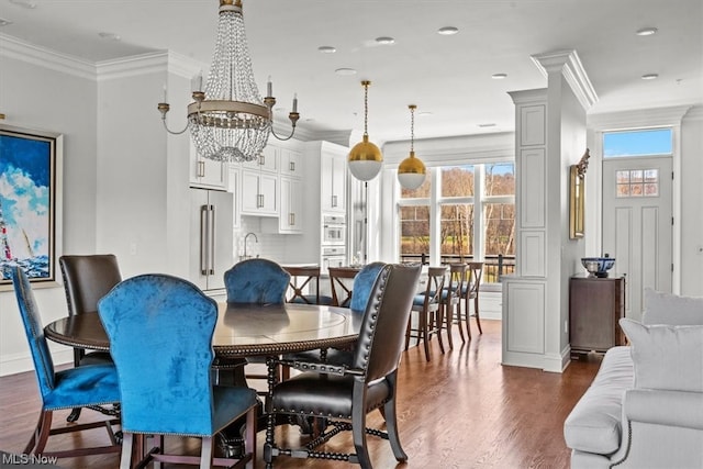 dining space with a chandelier, a wealth of natural light, and dark hardwood / wood-style flooring