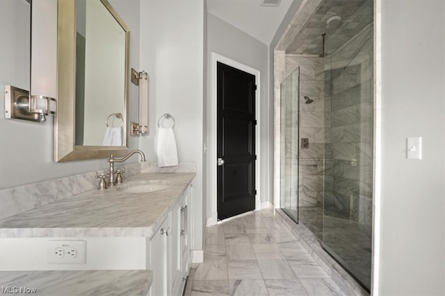 bathroom with walk in shower, tile flooring, and vanity