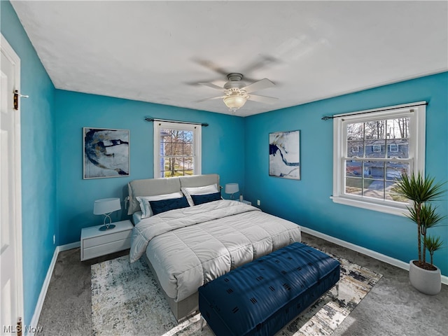 bedroom featuring dark carpet and ceiling fan