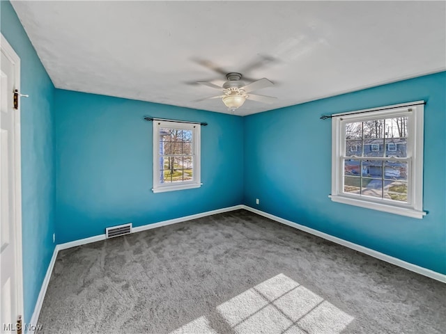 empty room featuring ceiling fan and carpet floors