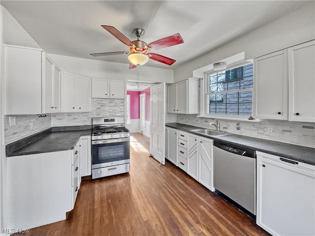 kitchen featuring dark hardwood / wood-style flooring, white cabinetry, stainless steel appliances, ceiling fan, and sink