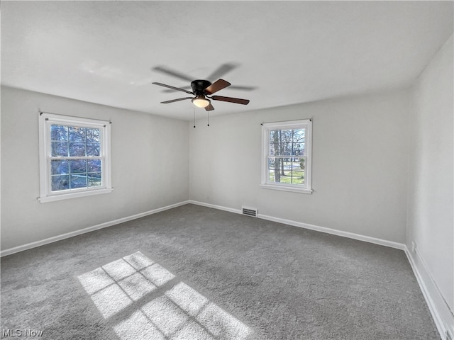 carpeted empty room featuring ceiling fan