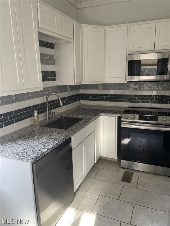 kitchen with sink, stainless steel appliances, and white cabinets