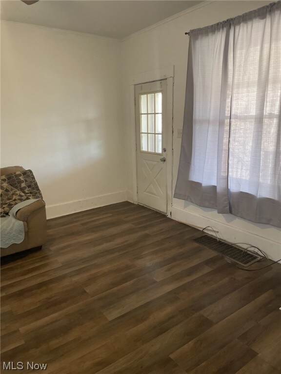 doorway with dark wood-type flooring