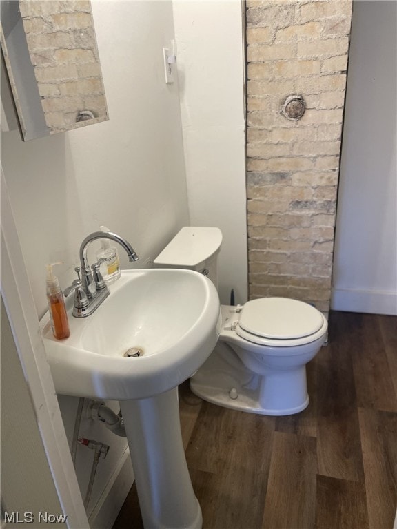 bathroom with sink, hardwood / wood-style flooring, and toilet