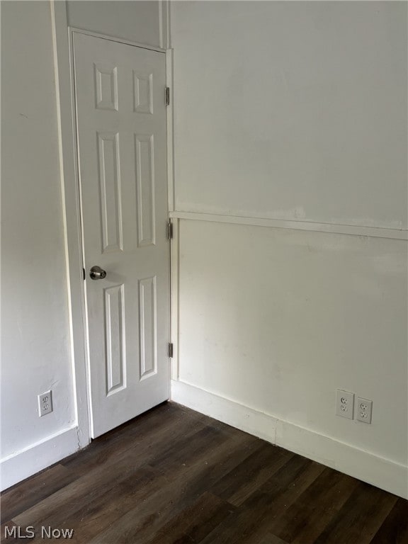 spare room with dark hardwood / wood-style flooring