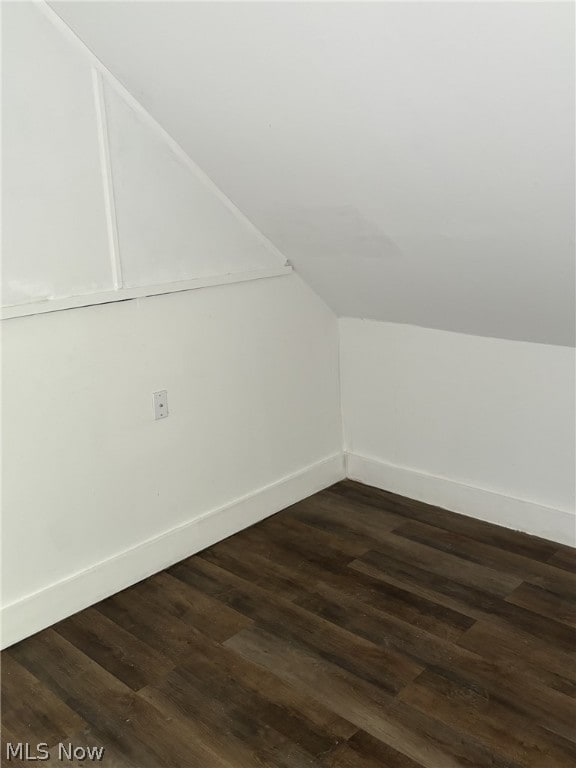 bonus room with dark hardwood / wood-style floors and lofted ceiling