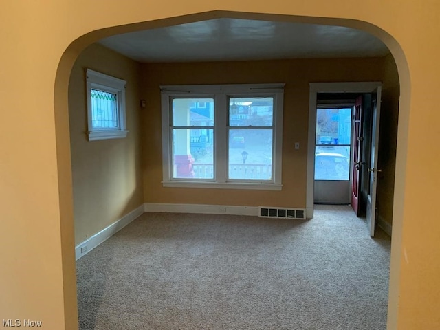 unfurnished room with light colored carpet