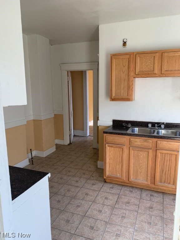 kitchen with sink and light tile flooring