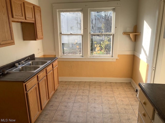 kitchen featuring light tile flooring, a healthy amount of sunlight, and sink