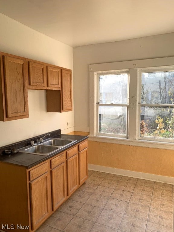 kitchen featuring sink and light tile floors