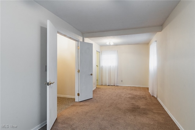 hall with light colored carpet