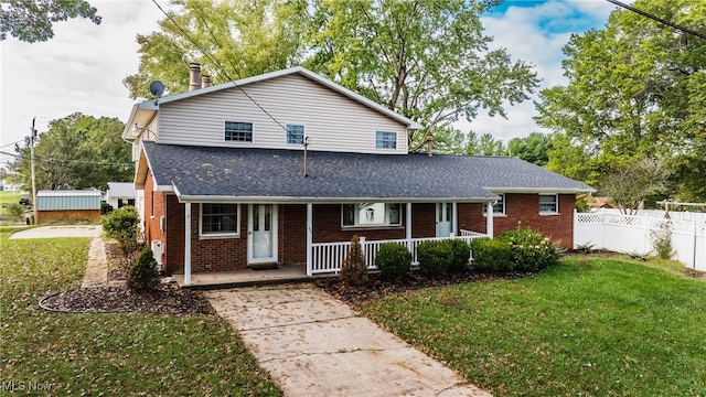 front of property with covered porch and a front yard