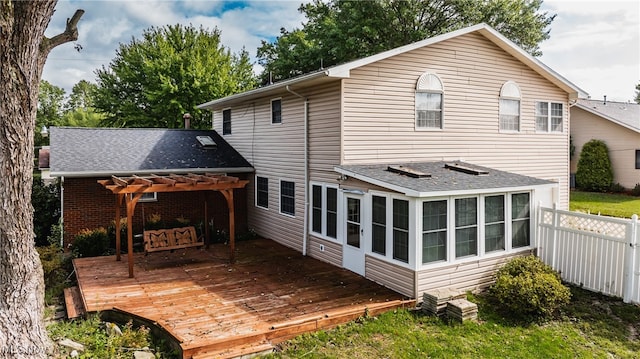 rear view of house with a sunroom, a pergola, and a deck