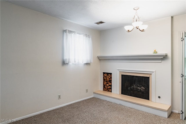 unfurnished living room with a notable chandelier and carpet