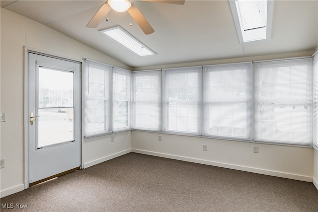 unfurnished sunroom with ceiling fan and lofted ceiling with skylight