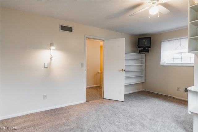 unfurnished bedroom featuring light carpet and ceiling fan