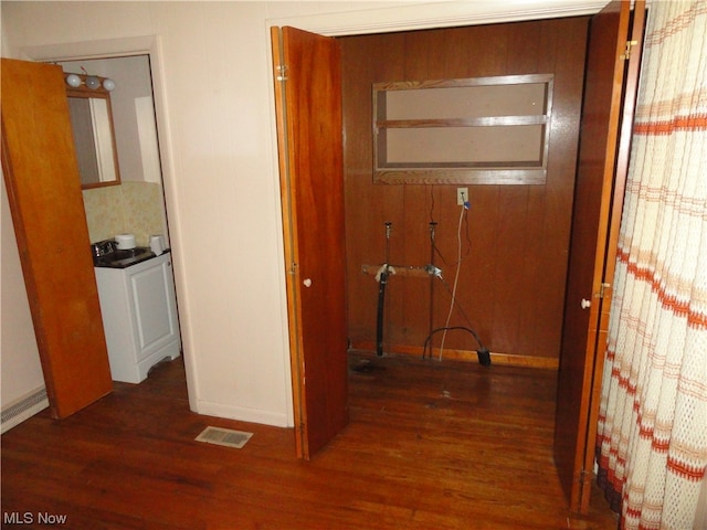 corridor featuring dark hardwood / wood-style flooring