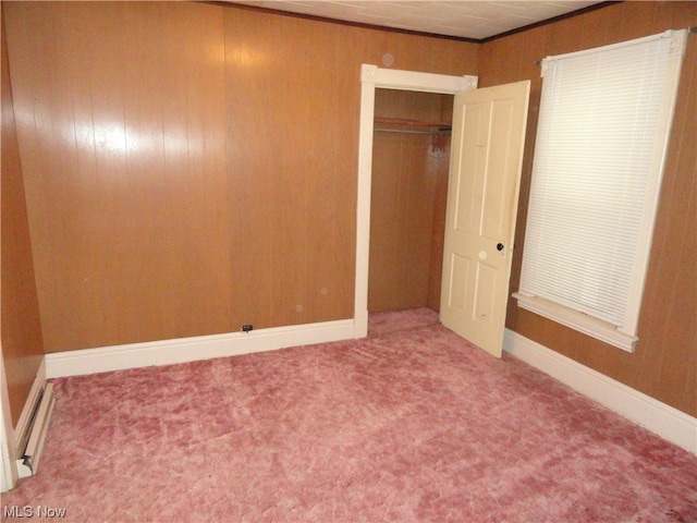 unfurnished bedroom featuring light carpet and a closet