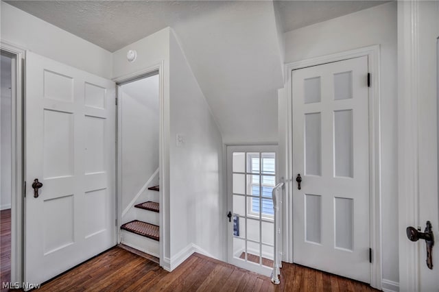 entrance foyer with dark hardwood / wood-style floors and a textured ceiling