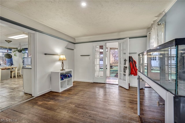 foyer entrance with plenty of natural light, dark hardwood / wood-style floors, a textured ceiling, and french doors