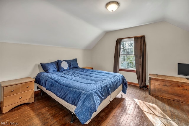 bedroom featuring dark hardwood / wood-style flooring and lofted ceiling