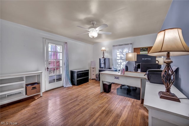 office featuring hardwood / wood-style flooring, ceiling fan, and a healthy amount of sunlight