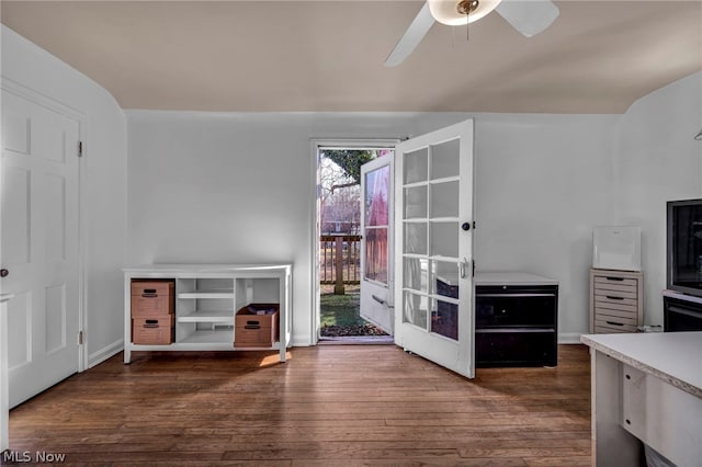 unfurnished bedroom with ceiling fan and dark hardwood / wood-style flooring