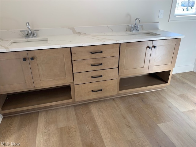 bathroom with wood-type flooring and sink