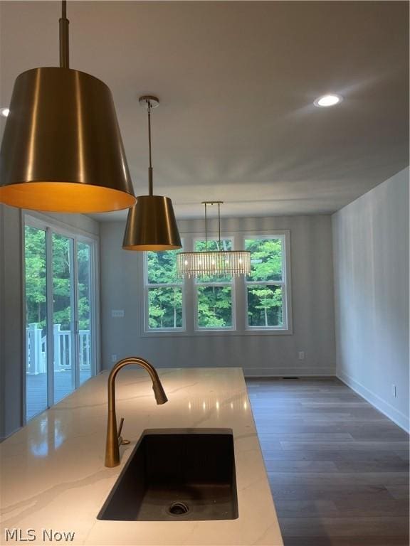 kitchen featuring decorative light fixtures, a chandelier, a wealth of natural light, and sink