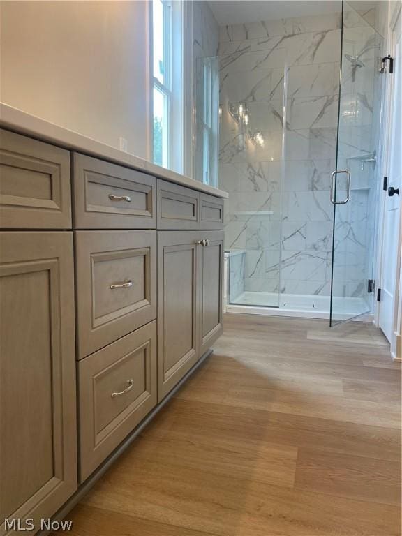 bathroom featuring walk in shower and hardwood / wood-style flooring