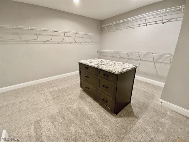 spacious closet with light colored carpet