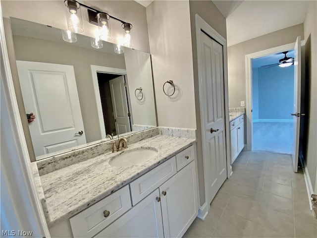 bathroom featuring tile patterned floors, ceiling fan, and vanity