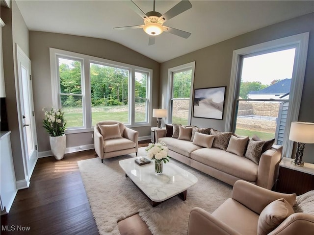 living room featuring dark hardwood / wood-style flooring, vaulted ceiling, ceiling fan, and a healthy amount of sunlight