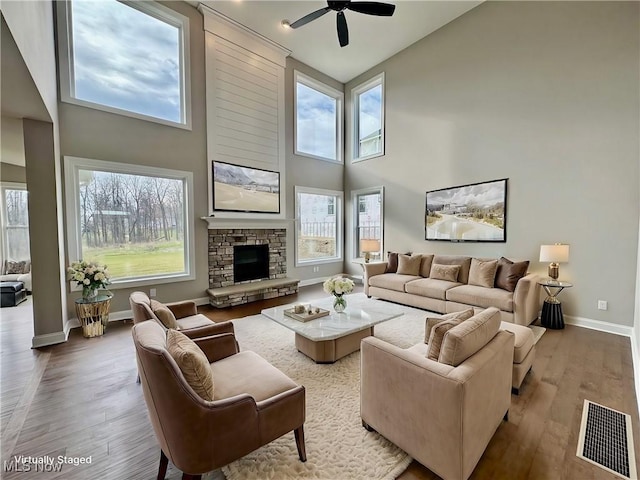 living room featuring hardwood / wood-style floors, a healthy amount of sunlight, and high vaulted ceiling