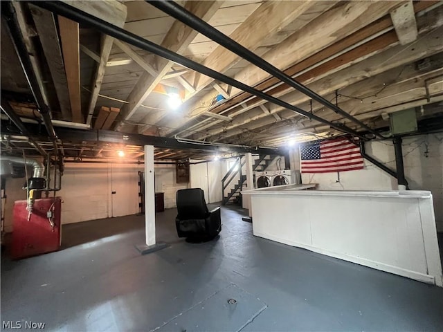 basement with electric panel and washer and clothes dryer