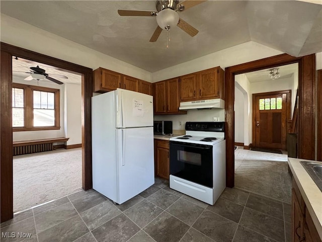 kitchen featuring dark colored carpet, electric range, radiator heating unit, white fridge, and ceiling fan