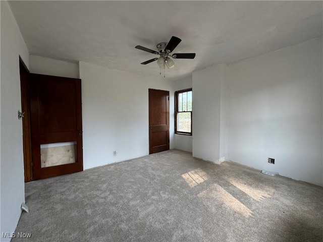 unfurnished bedroom featuring light carpet and ceiling fan