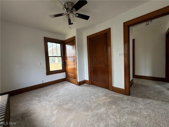 unfurnished bedroom featuring ceiling fan and light carpet