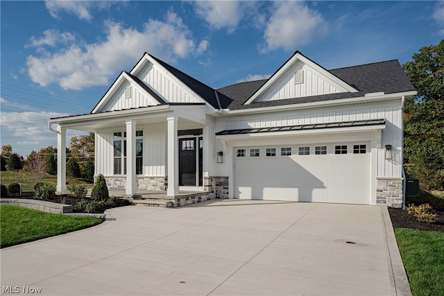 view of front of home with covered porch and a garage