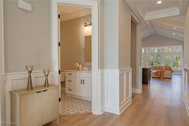 bathroom featuring crown molding, vanity, hardwood / wood-style flooring, and beam ceiling