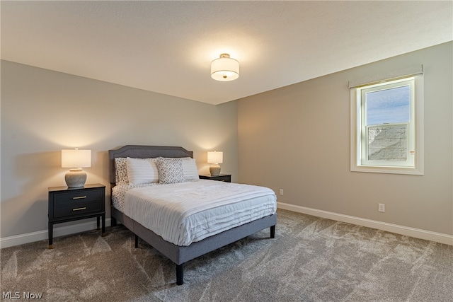 bedroom featuring dark carpet