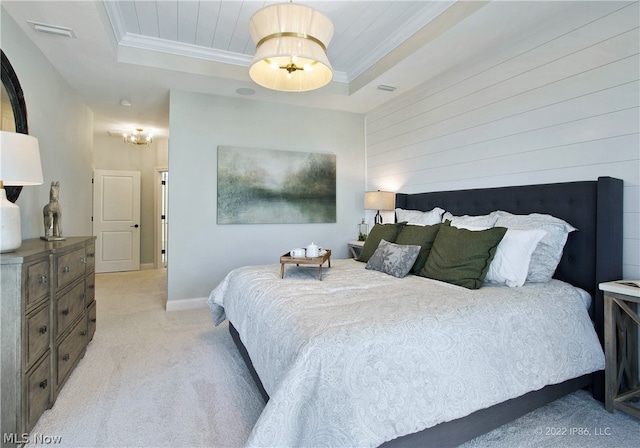 carpeted bedroom featuring a tray ceiling