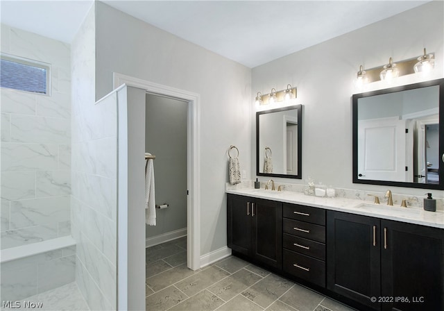 bathroom with tile patterned flooring and dual bowl vanity