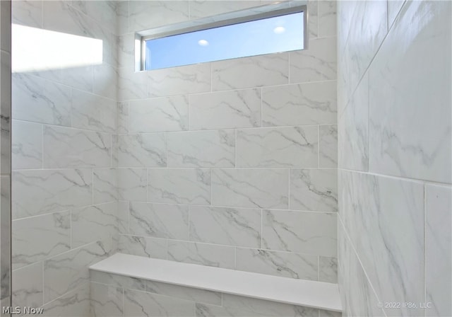 bathroom with tiled shower