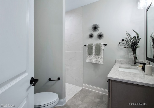 bathroom featuring vanity, tile patterned flooring, and toilet